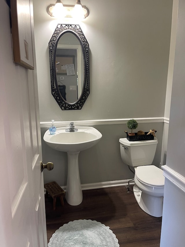 bathroom featuring hardwood / wood-style flooring, sink, and toilet