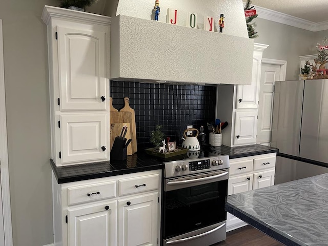 kitchen featuring backsplash, stainless steel appliances, crown molding, exhaust hood, and white cabinets