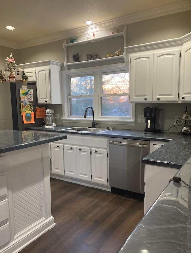 kitchen with dishwasher, dark wood-type flooring, sink, ornamental molding, and white cabinetry