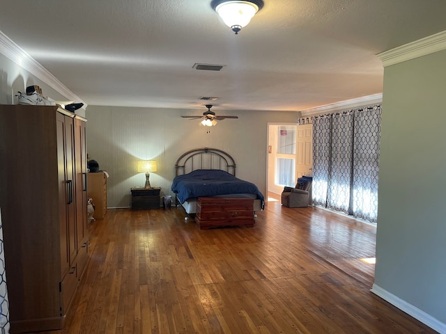 bedroom with dark hardwood / wood-style floors, ceiling fan, and crown molding