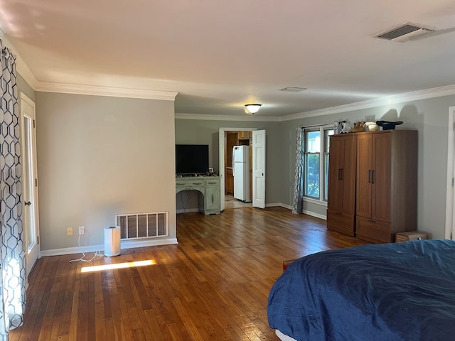 unfurnished bedroom featuring ornamental molding, white refrigerator, and dark wood-type flooring