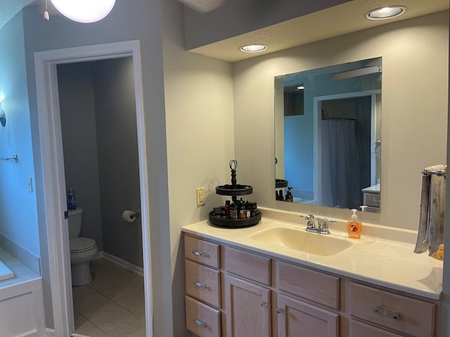 bathroom with tile patterned floors, vanity, and toilet