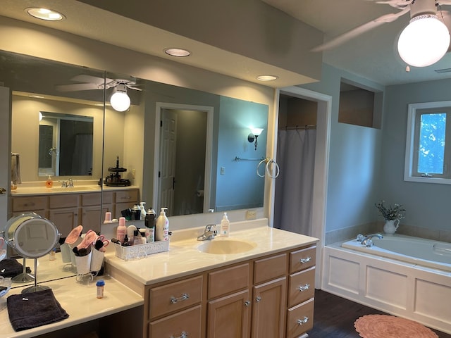 bathroom with a washtub and vanity