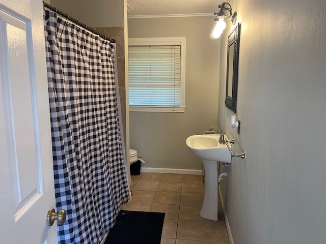 bathroom with toilet, tile patterned floors, and ornamental molding