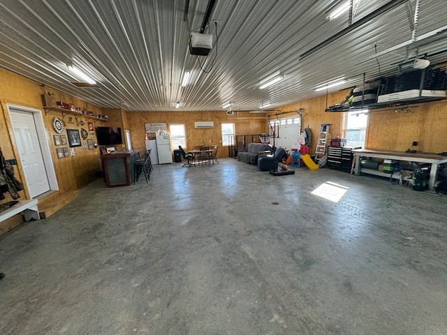 10344 Lantern Rd, Greentop, MO 63546 - garage with a workshop area, wood walls, and a garage door opener