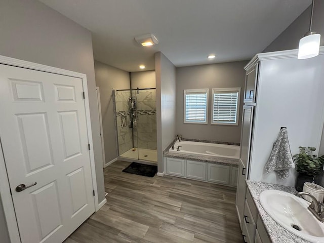 bathroom with vanity, hardwood / wood-style flooring, and independent shower and bath