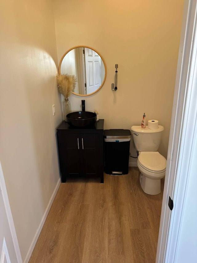 bathroom with vanity, hardwood / wood-style floors, and toilet