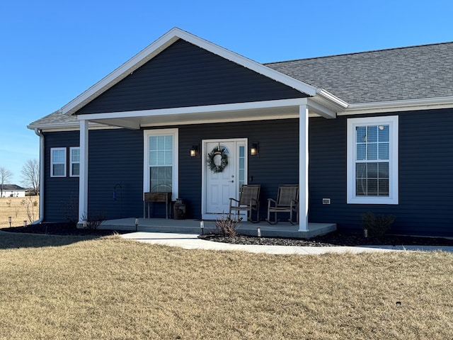 ranch-style house featuring a front yard and a porch