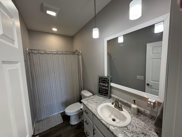 bathroom featuring hardwood / wood-style flooring, vanity, and toilet