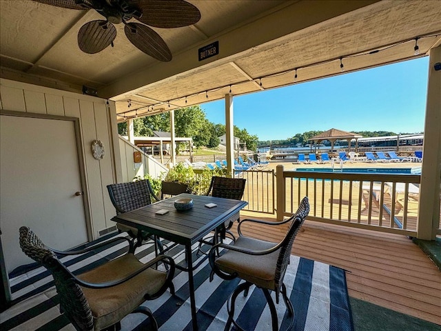 exterior space with ceiling fan and a community pool