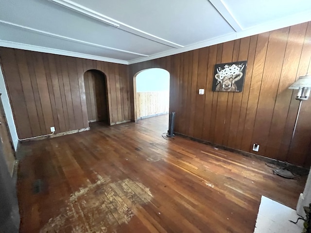 115 Polk St, Chillicothe, MO 64601 - empty room featuring arched walkways, dark wood-style floors, and wooden walls