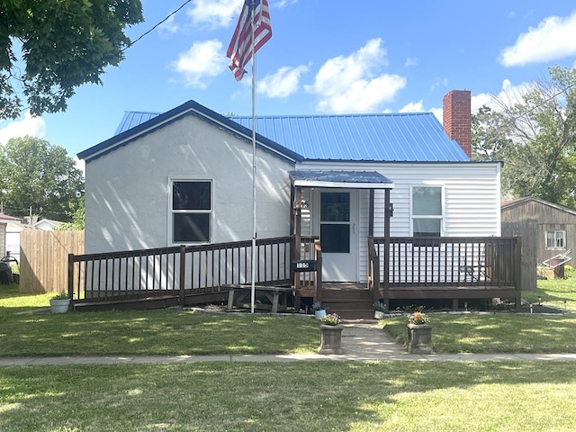115 Polk St, Chillicothe, MO 64601 - rear view of property featuring a yard, a deck, and a metal roof