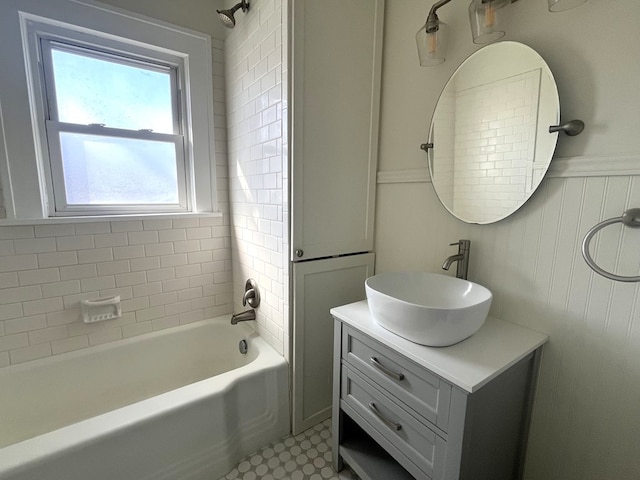 bathroom featuring a wainscoted wall, vanity, and washtub / shower combination