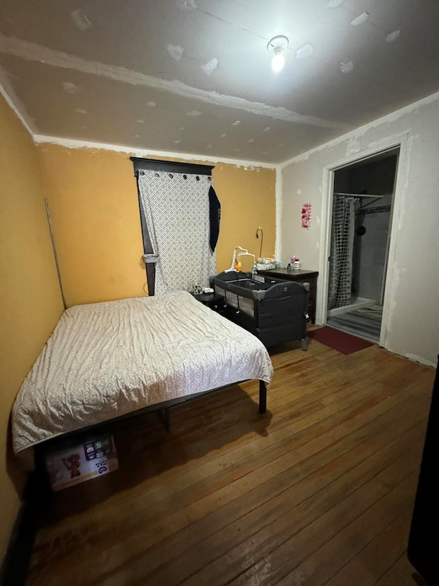 bedroom featuring wood-type flooring, a spacious closet, and a closet