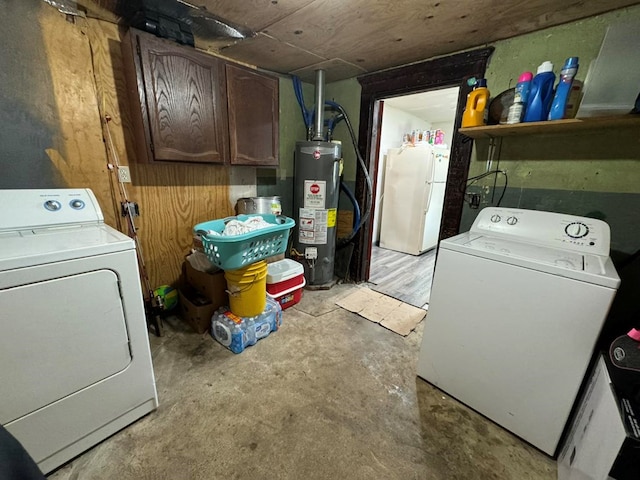 clothes washing area with cabinets, separate washer and dryer, and water heater