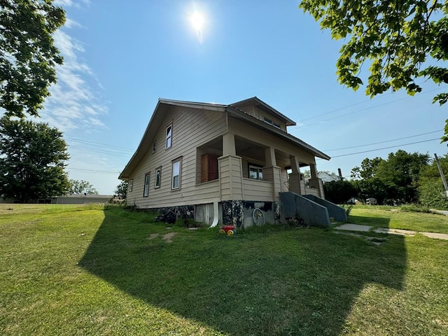 view of side of property with a lawn