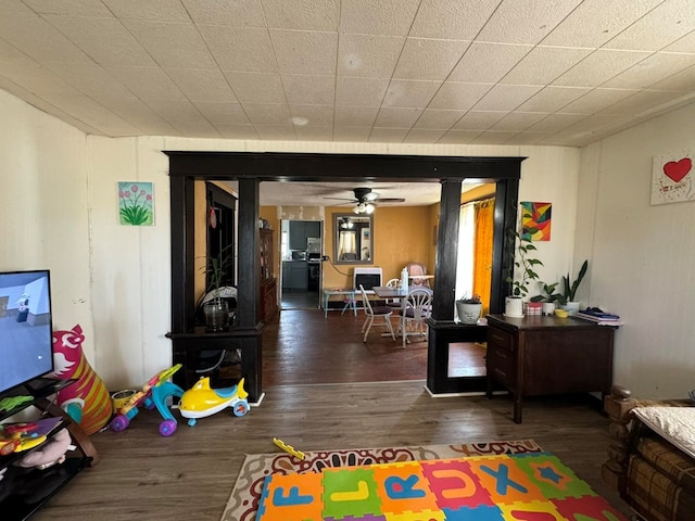 game room with ceiling fan and dark hardwood / wood-style floors