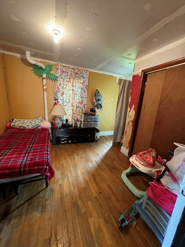 bedroom featuring hardwood / wood-style flooring and a closet