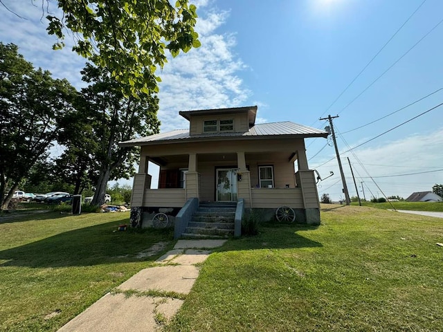 bungalow with a porch and a front yard