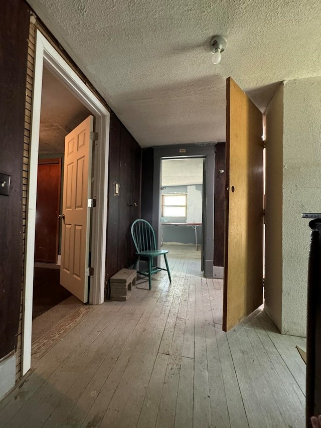 hallway with light hardwood / wood-style flooring