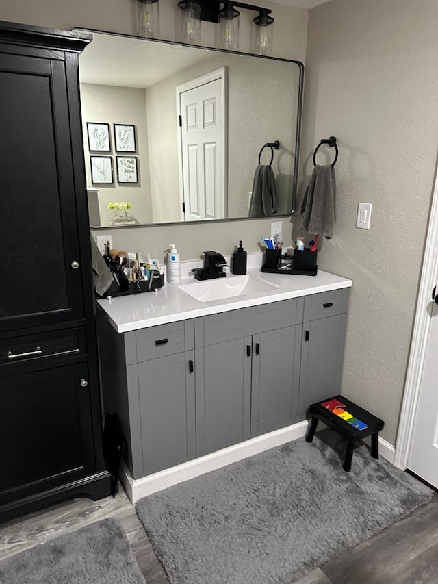 bathroom with hardwood / wood-style floors and vanity