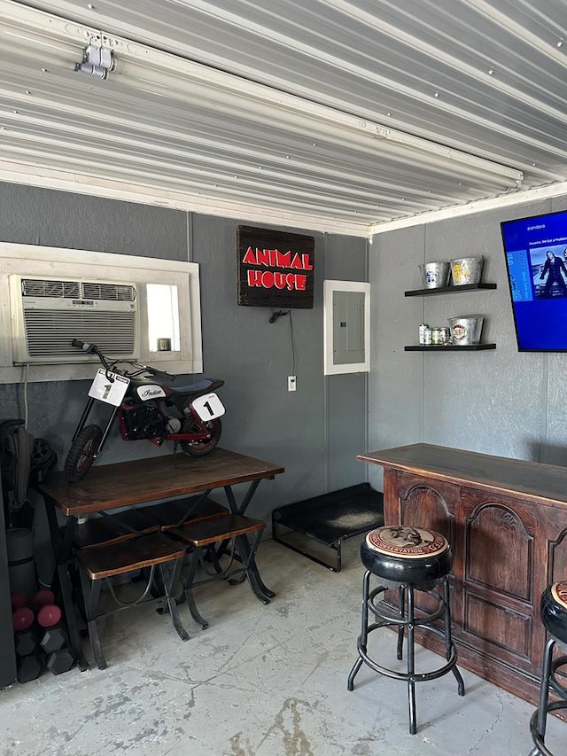 interior space with a wall unit AC and electric panel