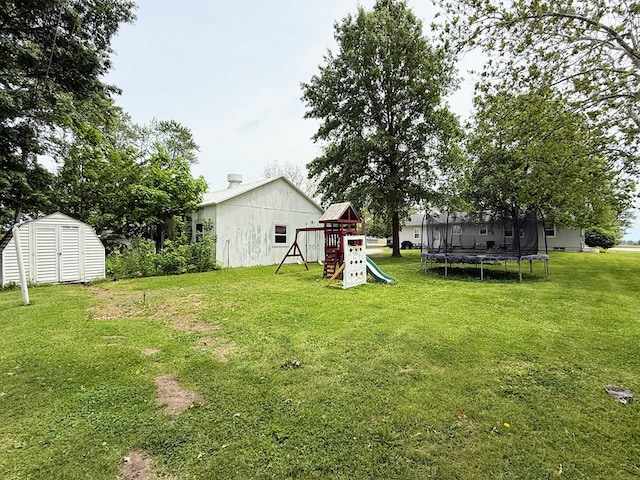 609 E Clark St, La Plata, MO 63549 - view of green lawn with a playground and a trampoline