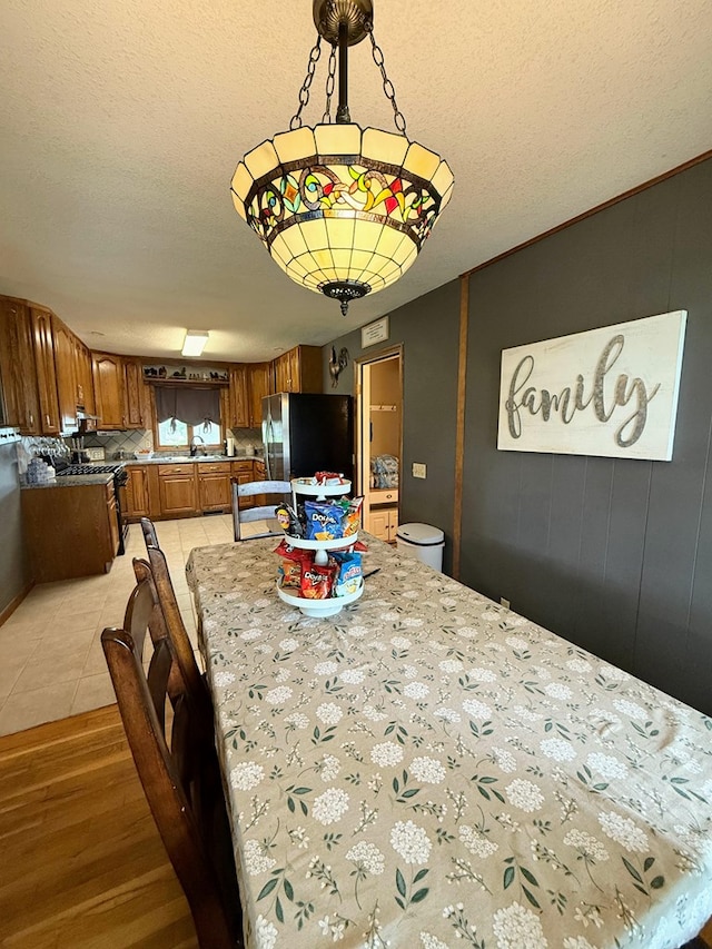 609 E Clark St, La Plata, MO 63549 - dining room with a textured ceiling and light tile patterned floors