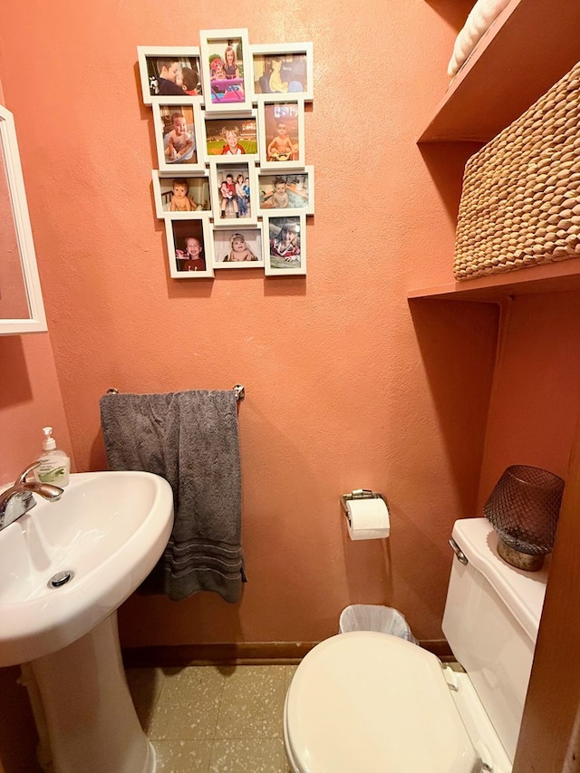 609 E Clark St, La Plata, MO 63549 - half bathroom with toilet, tile patterned floors, and baseboards