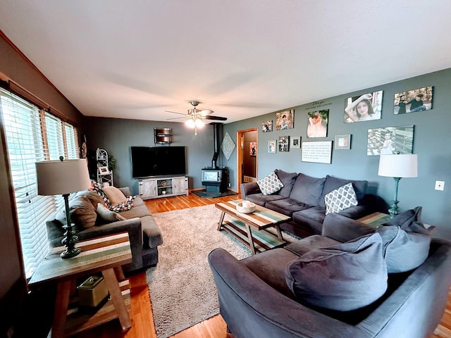 609 E Clark St, La Plata, MO 63549 - living room with a wood stove, light wood-style flooring, and ceiling fan