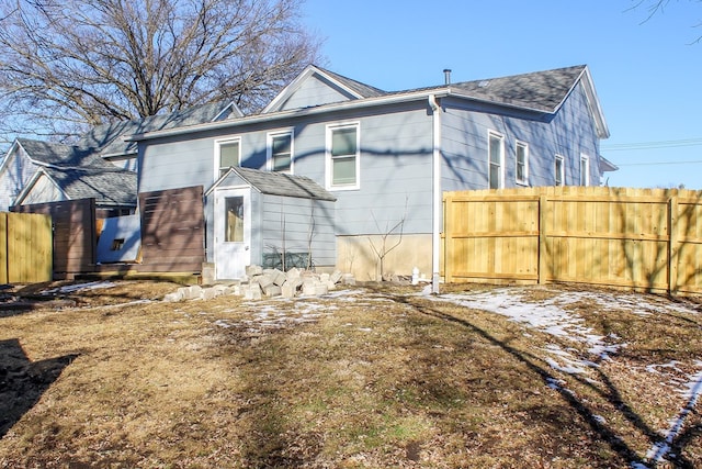 back of house featuring fence