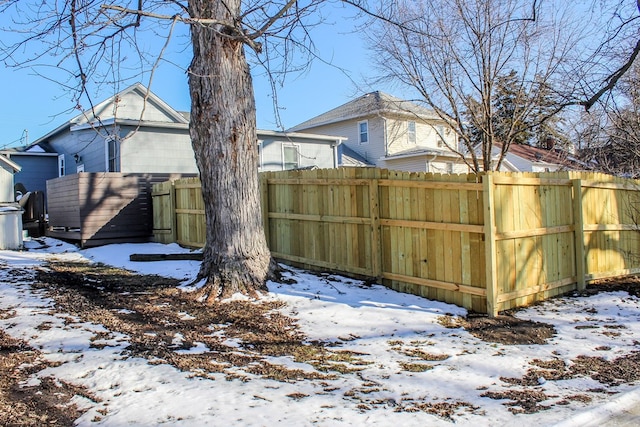 yard covered in snow with fence