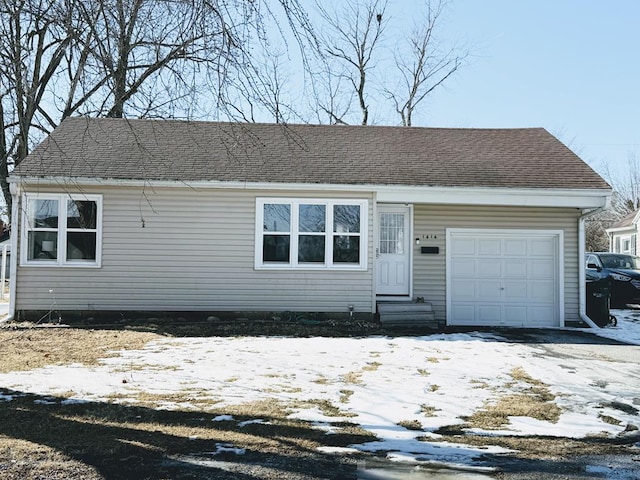 view of front facade with a garage, roof with shingles, and entry steps