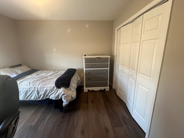 bedroom featuring a closet and dark wood finished floors