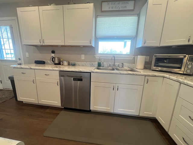 kitchen featuring dishwasher, white cabinets, a wealth of natural light, and a sink