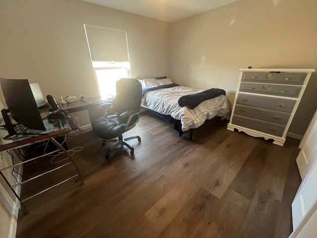 bedroom with dark wood finished floors