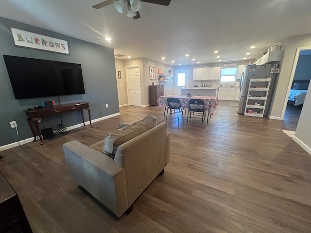 living area with recessed lighting, baseboards, dark wood-type flooring, and a ceiling fan