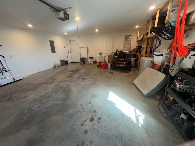 garage with electric panel and a garage door opener