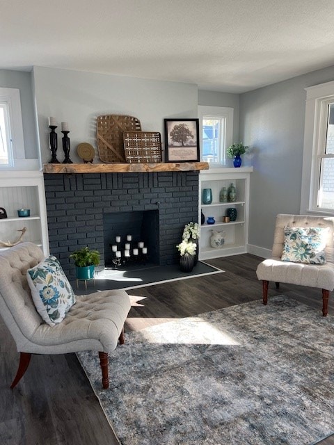 living room with hardwood / wood-style floors and a fireplace