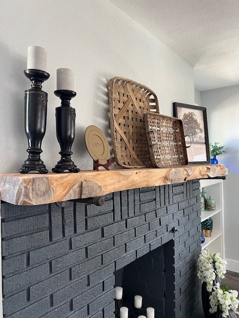 interior details featuring a fireplace and a textured ceiling