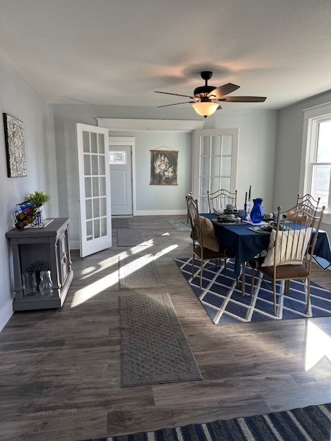 dining room featuring ceiling fan, dark wood-type flooring, and french doors