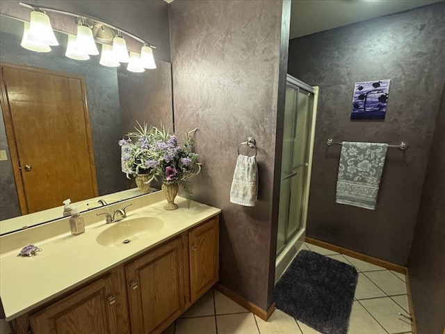 bathroom featuring an enclosed shower, vanity, and tile patterned flooring