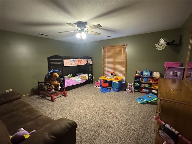 game room featuring ceiling fan, carpet flooring, and a textured ceiling