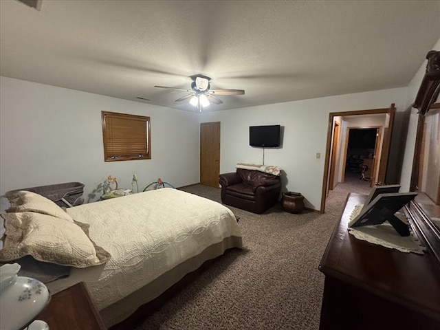 carpeted bedroom with a textured ceiling and ceiling fan