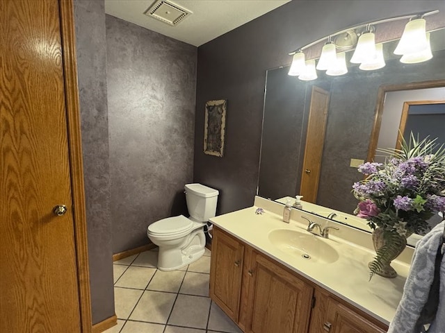 bathroom with vanity, toilet, and tile patterned flooring