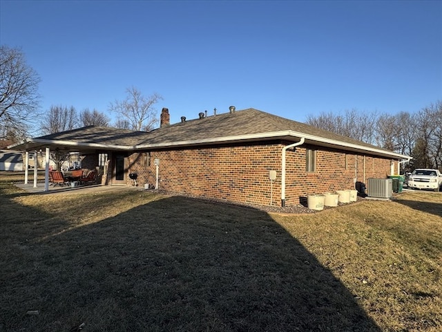 view of side of property with cooling unit, a patio, and a lawn