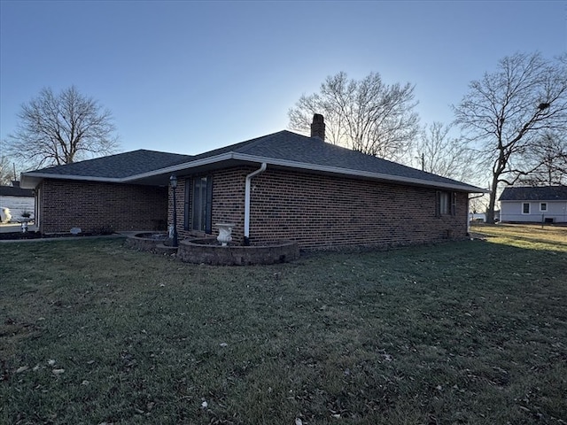 view of side of property with a yard