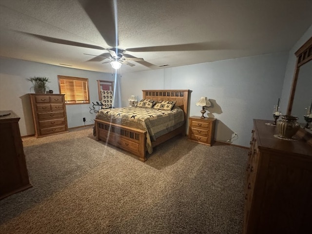 bedroom featuring ceiling fan, carpet flooring, and a textured ceiling