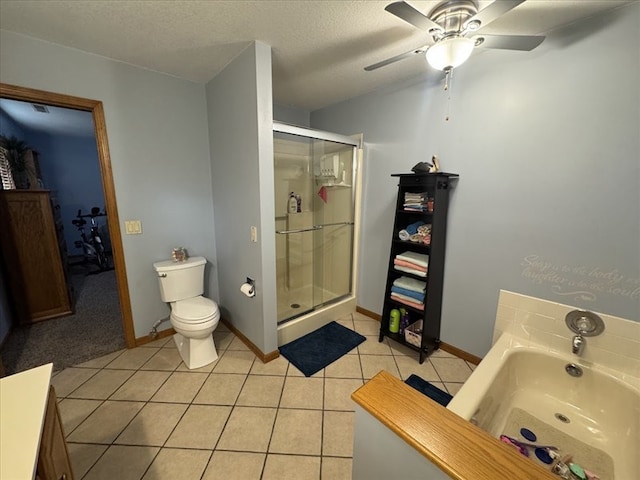 bathroom with ceiling fan, tile patterned flooring, an enclosed shower, a textured ceiling, and toilet