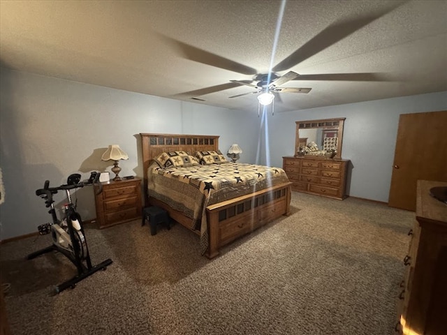 carpeted bedroom with ceiling fan and a textured ceiling